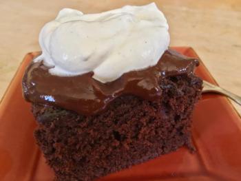 Warm chocolate olive oil cake with my notorious shiny dark chocolate boiled frosting, and a dollop of fresh whipped cream. SUZI THAYER/Boothbay Register