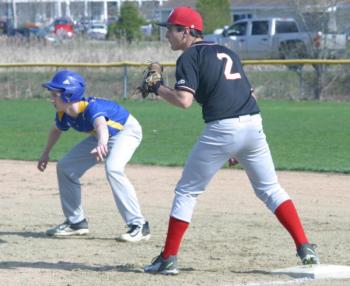 Matt Eckert holds Boothbay’s Brett Hollowell on first. PHIL DI VECE/Wiscasset Newspaper