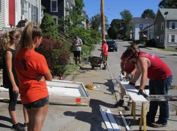 Members of St. Paul’s United Church of Christ work outside a home on Middle Street in Bath. PHIL DI VECE/Wiscasset Newspaper