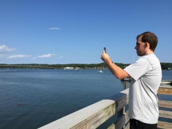 Daniel Palen photographs the Wiscasset waterfront Aug. 5. SUSAN JOHNS/Wiscasset Newspaper