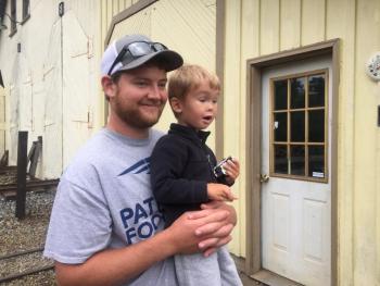 Spruce Head’s Thomas McLennan and son Mason McLennan, 2, watch a train. SUSAN JOHNS/Wiscasset Newspaper