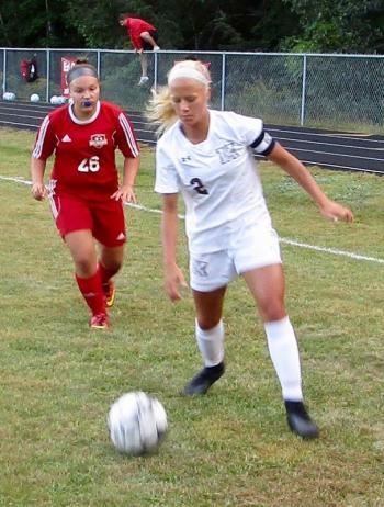 Jasmine Rego in pursuit of Monmouth’s Audrey Fletcher. PHIL DI VECE/Wiscasset Newspaper