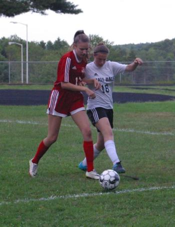 Alyssa Bassett goes shoulder to shoulder with Hall-Dale’s Samantha Thornton. PHIL DI VECE/Wiscasset Newspaper
