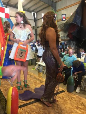 “Purple Reign” a Hollylyu Design modeled by Luanne Webb (foreground) and Riley Sullivan wears her mom, Kathryn Sullivan’s design in which navigation maps were used. LISA KRISTOFF/Boothbay Register