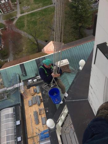 Mid-Maine Restoration’s work on clock towers, church steeples and the like requires crew members to toil at great heights. Courtesy of Mid-Maine Restoration colby college, mid-maine restoration