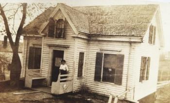 Edna Jones, previous owner, stands on the porch of her family’s Wiscasset home years ago. Was she turning the lights off? Courtesy of Pam Logan