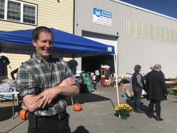 Ames True Value co-owner Wayne Averill looks out on the parking lot that had a bounce house and rows of cornhole boards. SUSAN JOHNS/Wiscasset Newspaper