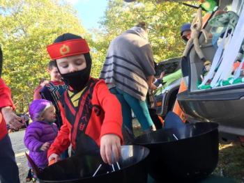 Whyatt Dutton, 4, of Gardiner reaches for treats at Huntoon Hill Grange's Trick or Trunk event Sunday, Oct. 21 in Wiscasset. SUSAN JOHNS/Wiscasset Newspaper