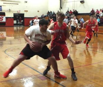 Wolverine Matt Chapman attempts to block Conlon Ranta’s drive to the basket. PHIL DI VECE/Wiscasset Newspaper