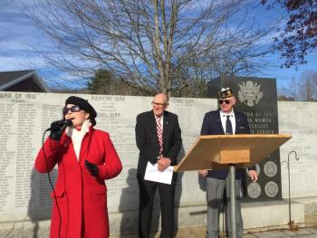 Denise Reynolds sings "America the Beautiful" in front of the veterans wall at American Legion Post 54's Veterans Day service Nov. 11. SUSAN JOHNS/Wiscasset Newspaper