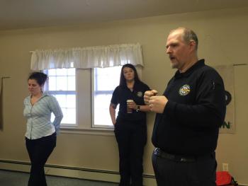 From left, Wiscasset Ambulance Service members Meriel Longley and Lina Wallace stand by as Jon Powers speaks with participants. SUSAN JOHNS/Wiscasset Newspaper