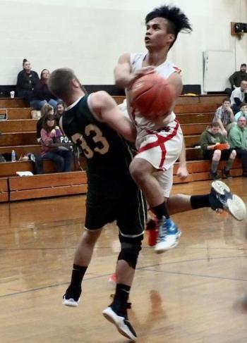 Chris Loyola drives to the basket over Carrabec’s Lucas Murray in the fourth period. PHIL DI VECE/Wiscasset Newspaper
