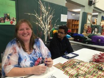 Kristy Lincoln of Wiscasset and Muhammad Khalique of Pakistan man the After School Adventures table. SUSAN JOHNS/Wiscasset Newspaper