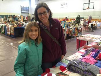 Corinne Joyce, 8, of Wiscasset and her mother Sarah Joyce check out the table of fellow resident Joan Reed at the Holiday Market at Wiscasset Community Center Dec. 1. SUSAN JOHNS/Wiscasset Newspaper