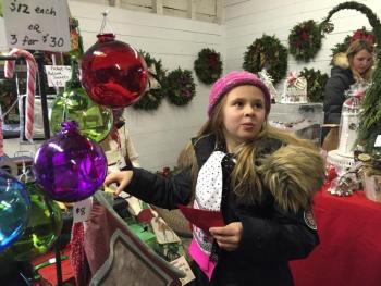 Natalie Dunbar, 8, checks out crafts Saturday at a show inside the barn of Nickels-Sortwell House. SUSAN JOHNS/Wiscasset Newspaper