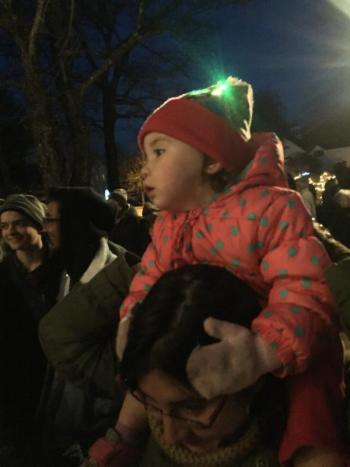 Alice Giles, 2, watches the chorus from atop the shoulders of her mother Holly Giles.SUSAN JOHNS/Wiscasset Newspaper