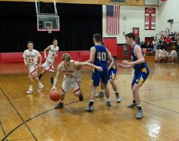 Matt Chapman makes a run to the basket. Also shown are Wiscasset’s Brett Osmond #23 and Josh Gabriele #4. PHIL DI VECE/Wiscasset Newspaper