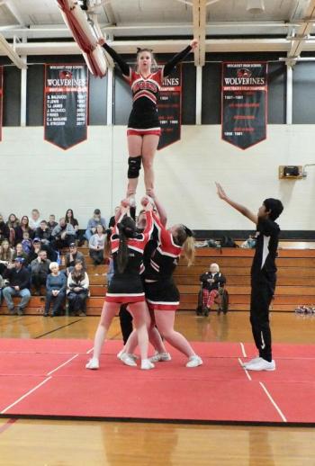Senior Justine Murphy gets a lift from her teammates during a halftime performance at Friday night’s game with Boothbay. The team was practicing for Saturday’s cheering competition and received applause from the fans. PHIL DI VECE/Wiscasset Newspaper