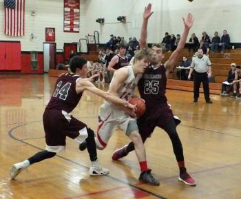Matt Chapman drives to the basket by Richmond’s Dak Gilpatric #14 and Calob Densmore #25. PHIL DI VECE/Wiscasset Newspaper
