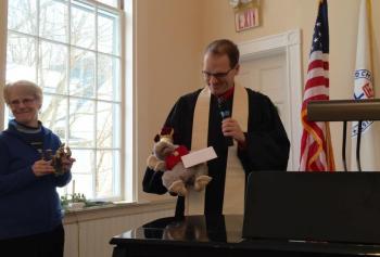 First Congregational Church of Wiscasset Pastor Josh Fitterling holds Charlie the Church Mouse, as one of the magi, during the Jan. 6 service. Looking on with the other magi figures is Libby Mooney. SUSAN JOHNS/Wiscasset Newspaper