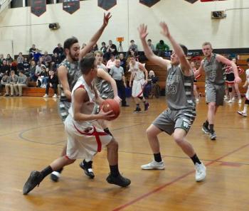 Josh Gabriele makes a break for the basket. Defending are Nate LeBlanc #33 and Cam Wood #45. PHIL DI VECE/Wiscasset Newspaper