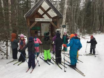 Students gather at the HVNC gatehouse at the start of the day to discuss trail conditions, weather, and itineraries. Courtesy of Juniper Hill School