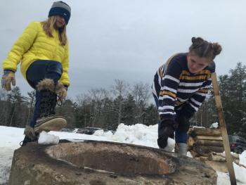 Jessie Willey, left, 10, of Dresden and Linnea Andersson, 12, of Wiscasset visit a bonfire at Winterfest Feb. 2. SUSAN JOHNS/Wiscasset Newspaper