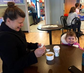 Wiscasset's Tiffany Monnett and granddaughter Emery Sanfratello, 2, of Wiscasset enjoy some macaroni and cheese at Winterfest. SUSAN JOHNS/Wiscasset Newspaper