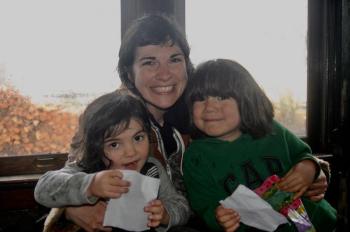 Kristin Dillon of Whitefield hugs Milo,3, and Oscar, 5 on the Easter Eggpress. ART MAYERS/Wiscasset Newspaper