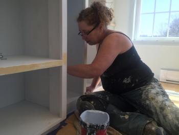 Denise Bizer paints shelving in the new town office April 5. SUSAN JOHNS/Wiscasset Newspaper