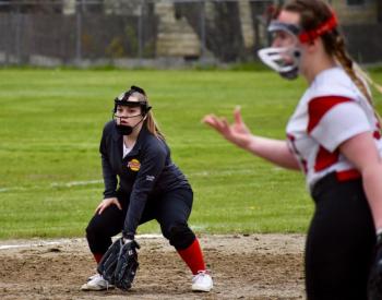 Kateleen Trask on third base watches as Wolverine pitcher Sydnie Thayer delivers a pitch in the first game of a twin bill with Dirigo. PHIL DI VECE/Wiscasset Newspaper