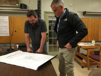Wiscasset Planning Board member Jason Putnam, left, and Chris Nadeau of Nobis Group look at the final plans for a Dollar General May 13. SUSAN JOHNS/Wiscasset Newspaper