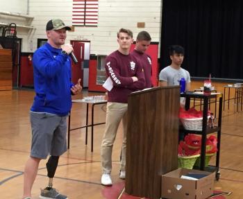 Travis Mills Foundation ambassador Michael Liscomb speaks as Student Council members, from left, Matt Chapman, Caleb Gabriele and Chris Loyola look on. SUSAN JOHNS/Wiscasset Newspaper