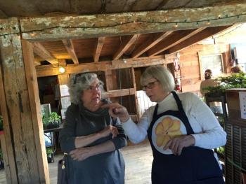Boothbay Harbor’s Marion Coleman, left, gets help from Morris Farm co-president Merry Fossel of Alna. SUSAN JOHNS/Wiscasset Newspaper