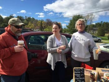 George Adams stops by the Beelicious table. The business’s owner, Monica Carrington, is at center. At right is Morris Farm Store operator Elizabeth Palmer. SUSAN JOHNS/Wiscasset Newspaper