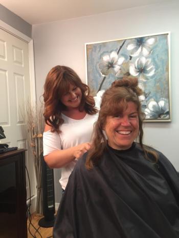 Possibilities Salon owner and Wiscasset School Committee member Desiree Bailey gives Wiscasset Middle High School librarian Cindy Carter a new look June 5, to benefit two causes. SUSAN JOHNS/Wiscasset Newspaper