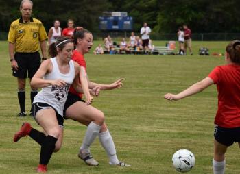 A good deal of action in the Wiscasset-Richmond game took place at midfield. That’s Wiscasset’s Gwen Webber in the center. PHIL DI VECE/Wiscasset Newspaper