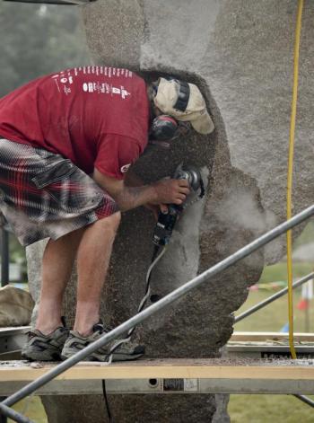 Artists, like Dan Ucci here, enthusiastically invite the public to interact with them and watch the sculptures develop, this year from July 27 to Aug. 4. It is sometimes noisy and dusty, but always fun. Courtesy photo Sculptor Dan Ucci