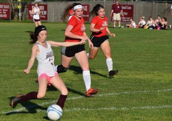 Nicoile Tribbett with the ball is pursued by Wiscasset’s Carolyn Potter, center, and Jasmine Rego. PHIL DI VECE Wiscasset Newspaper