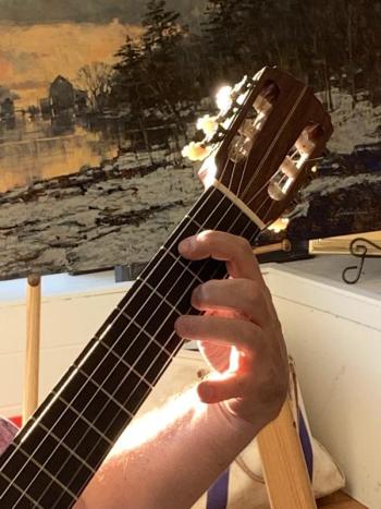 “Maine Magic” by Angelo Franco sits behind the guitar playing of Brunswick’s Jonathan Waldo inside Sylvan Gallery Aug. 29. SUSAN JOHNS/Wiscasset Newspaper