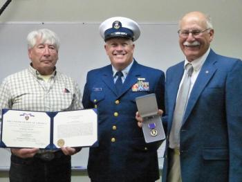 Douglas Bowers, left, and Fred Bowers, far right, family of Justin P. Wiley, accept the Purple Heart on behalf of Wiley’s family. Coast Guard Northern New England Sector Command Master Chief Christopher H. James, center, presented the award. Ross Ragan photo