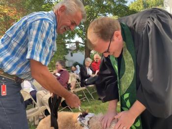 Sky Wentworth brings his and wife Michelle’s happy goldendoodle Sandy to meet with Rev. Josh Fittterling for a blessing. SUSAN JOHNS/Wiscasset Newspaper