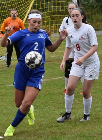 Kayla Cossette and Mt. Abram’s co-captain River Horn. That’s Wolverine goalie Lily Souza in the background. PHIL DI VECE/Wiscasset Newspaper