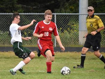 Wolverine Josh Jones and Carrabec’s Dimitri Turcotte pursue a loose ball. PHIL DI VECE/Wiscasset Newspaper