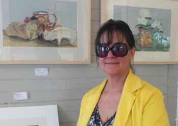 Karen “Kallena” Chutsky in front of two framed paintings she created at age 10. LISA KRISTOFF/Boothbay Register