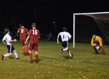 L J Travis scoops up a shot off the foot of Buckfield’s Zach Shield, #4. PHIL DI VECE/Wiscasset Newspaper