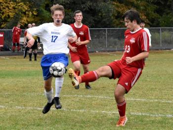 Wolverine Billy Pinkham goes up against Oak Hill’s Caleb Leighton. That’s Brian Foye in the background. PHIL DI VECE/Wiscasset Newspaper