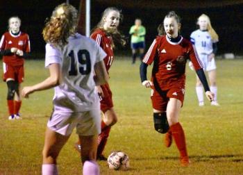 Wolverines Kylie Peoples, left, and Gwen Webber. Left background, Zoe Waltz. PHIL DI VECE/Wiscasset Newspaper