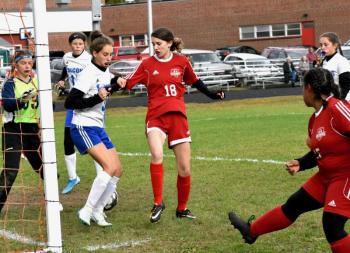 Natalie Potter #18 goes for a loose ball off the foot of Latisha Wright, shown on the right. PHIL DI VECE/Wiscasset Newspaper