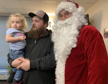 Riley Rines, 2, of Alna and her father John meet with Santa. SUSAN JOHNS/Wiscasset Newspaper